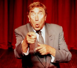 Comedian, Frankie Howerd, on stage.